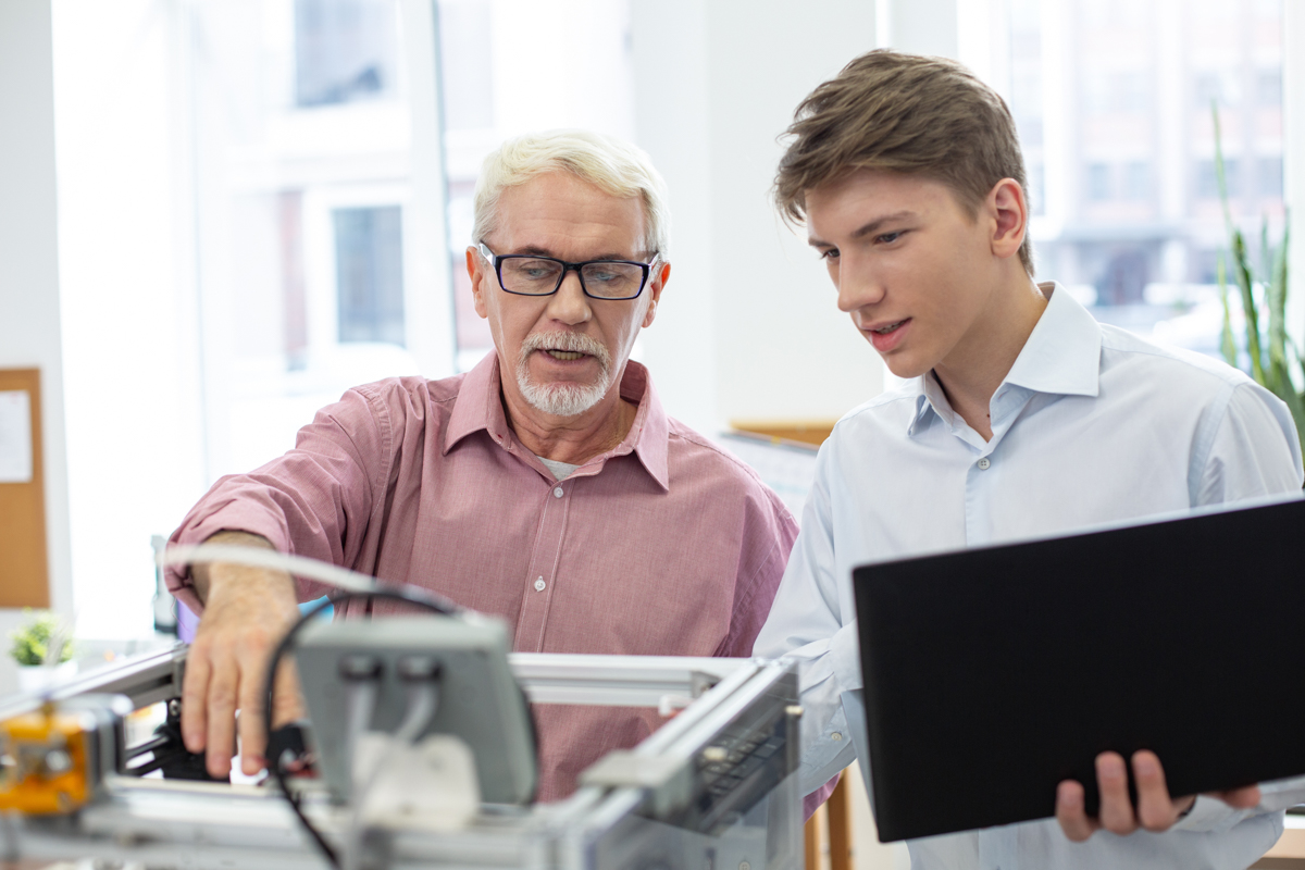 A senior lecturer teaching his young student.